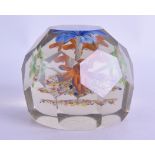 A LARGE ANTIQUE GLASS PAPERWEIGHT with upright blue flower and facetted body. 8 cm x 9.5 cm.