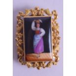 AN ANTIQUE 18CT GOLD MOUNTED PORCELAIN BROOCH painted with a female dancing within an interior. 3 cm