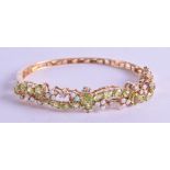 A STYLISH 14CT YELLOW GOLD DIAMOND OPAL AND PERIDOT HINGED BANGLE. 21.1 grams. 7 cm wide.