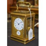 A FRENCH REPEATING BRASS CARRIAGE CLOCK with finely engraved brass face plate and multi dial. 16.5