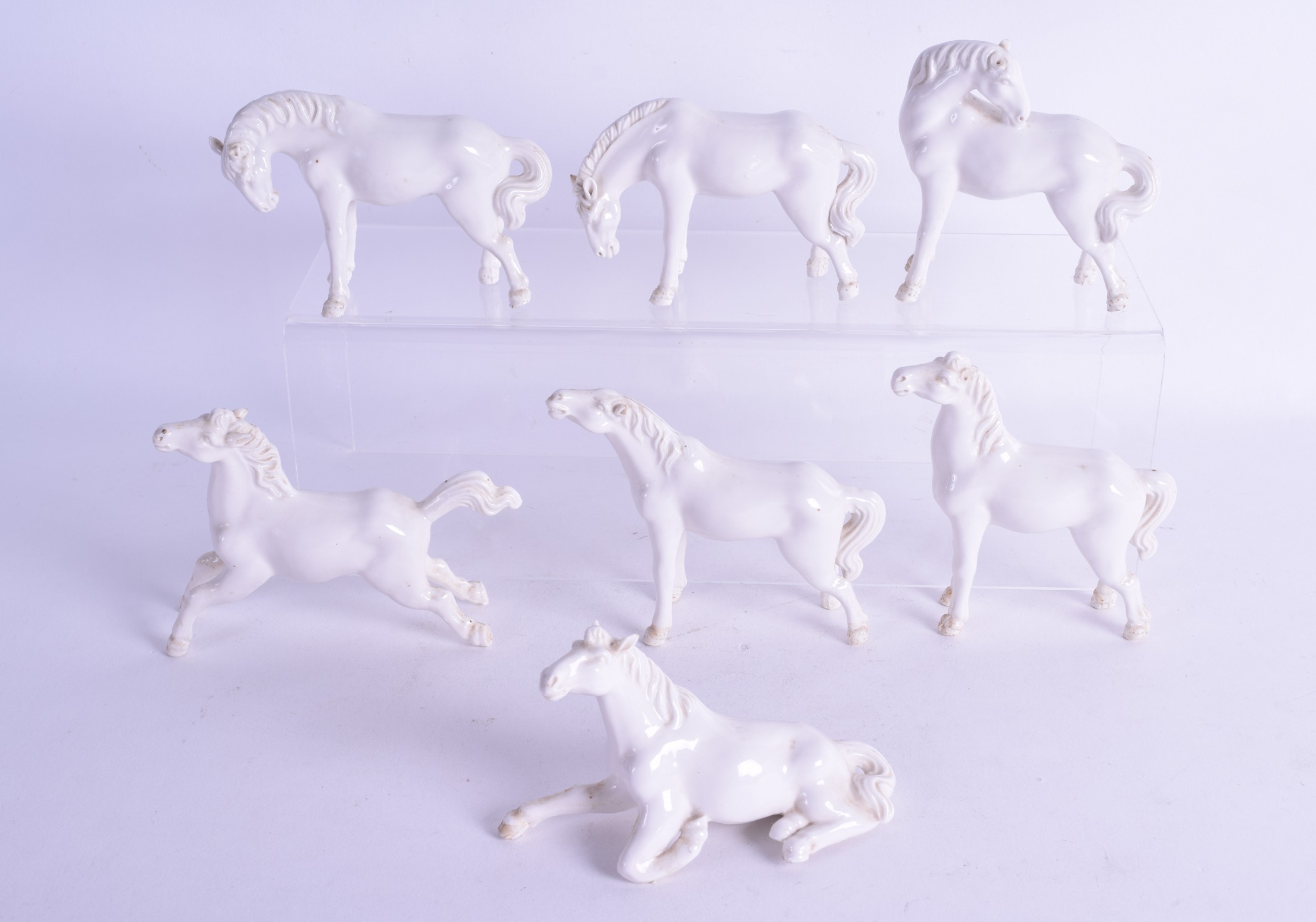 A SET OF SEVEN EARLY 20TH CENTURY CHINESE BLANC DE CHINE HORSES in various forms and sizes.