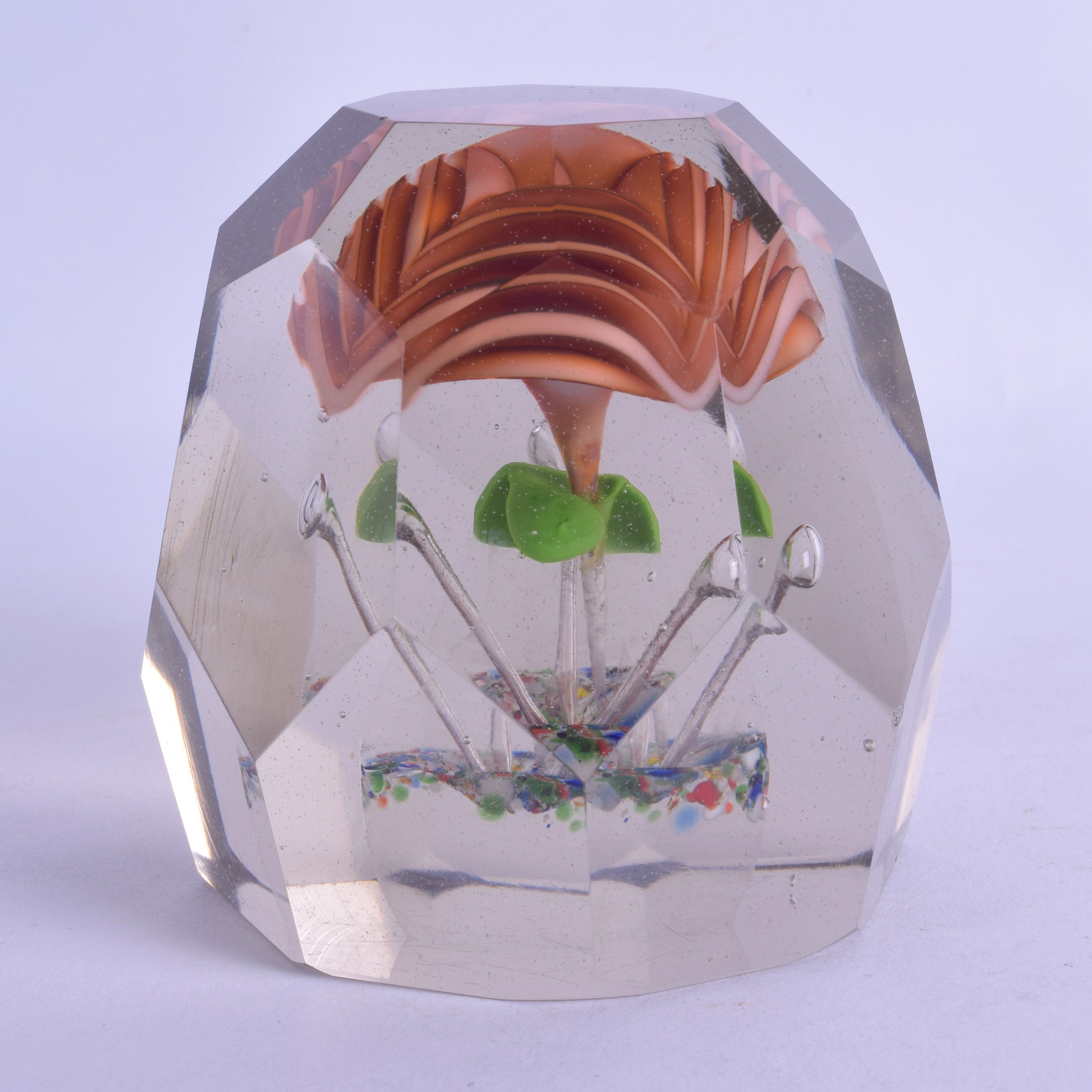A LARGE ANTIQUE GLASS PAPERWEIGHT with upright pink flower and facetted body. 9.5 cm x 9 cm.