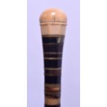 A MID 19TH CENTURY CARVED SECTIONAL HORN AND IVORY WALKING CANE with facetted terminal. 78 cm long.