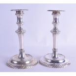 A PAIR OF 17TH/18TH CENTURY EUROPEAN SILVER CANDLESTICKS with ridged decoration to sconce and