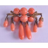 AN ANTIQUE YELLOW GOLD AND CARVED RED CORAL BROOCH. 15.6 grams. 7 cm wide.