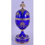 A FINE RUSSIAN SILVER GILT AND BLUE ENAMEL MANTEL CLOCK the egg shaped top opening to reveal a