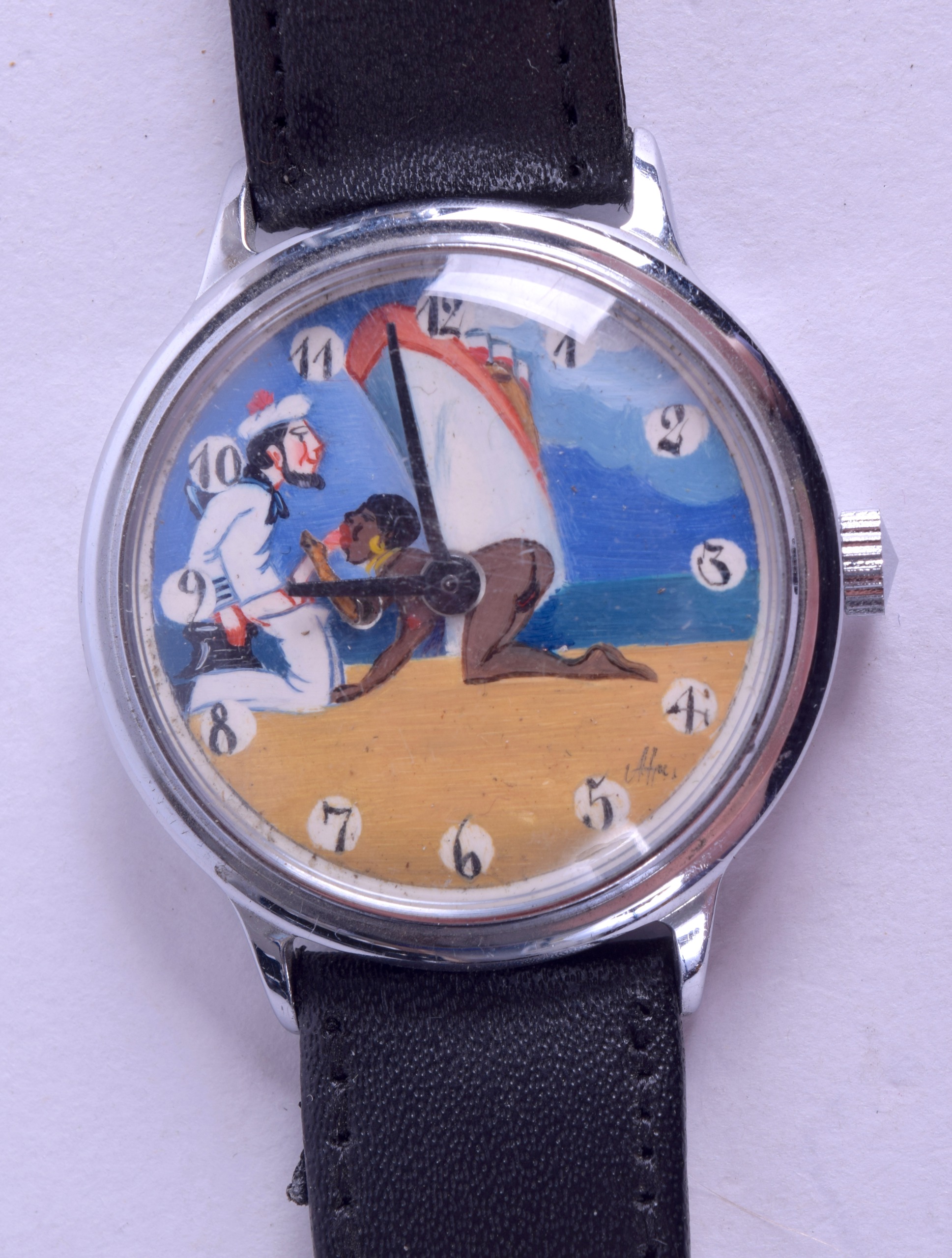 A GENTLEMANS EROTIC WRIST WATCH depicting a kneeling sailor relaxing in front of the cruise liner.