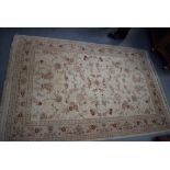 A BEIGE GROUND RUG, decorated with foliage. 195 cm x 124 cm.