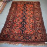 AN ORANGE GROUND PERSIAN RUG, decorated with motifs. 197 cm x 130 cm.