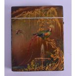 A LARGE VICTORIAN LACQUERED PAPIER MACHE CARD CASE painted with parrots, fountains and landscapes.