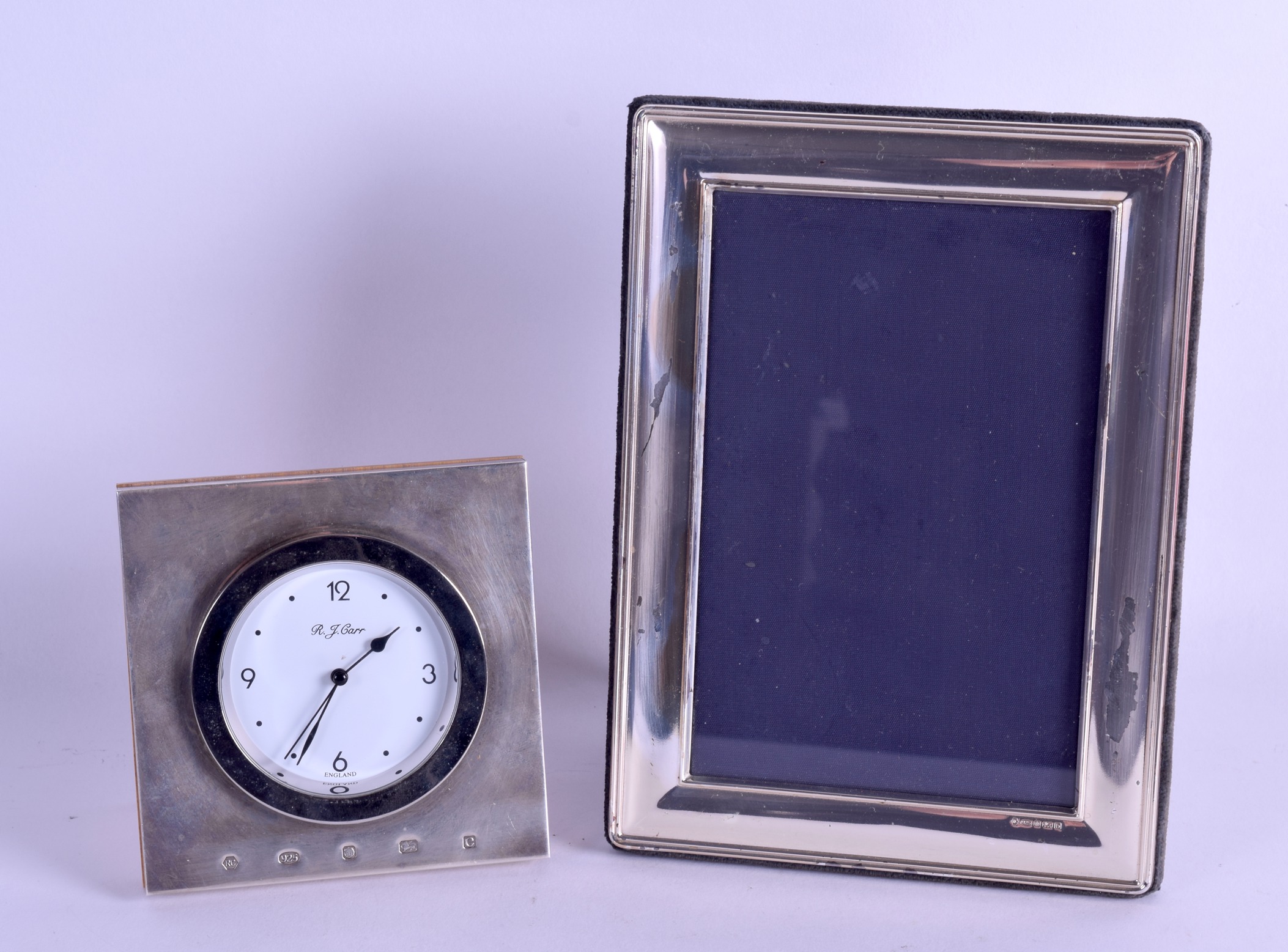 A MODERN ENGLISH SILVER STRUT DESK CLOCK together with a matching silver photograph frame. Clock