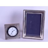 A MODERN ENGLISH SILVER STRUT DESK CLOCK together with a matching silver photograph frame. Clock