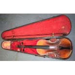 AN EARLY 20TH CENTURY CASED VIOLIN, together with a bow.