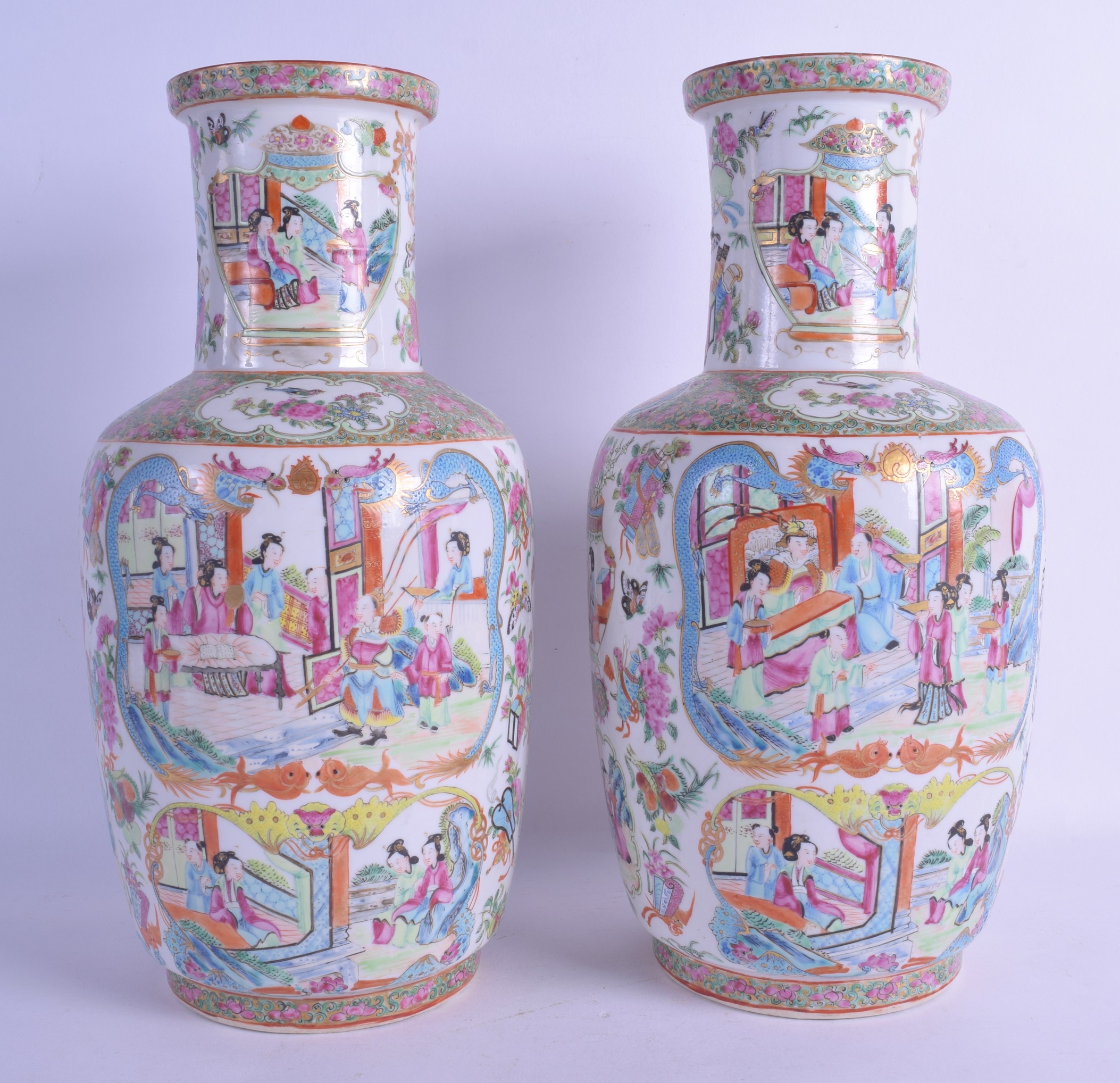 A GOOD PAIR OF 19TH CENTURY CHINESE CANTON FAMILLE ROSE ROULEAU VASES painted with figures, blue