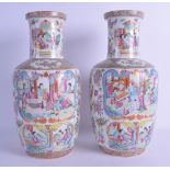 A GOOD PAIR OF 19TH CENTURY CHINESE CANTON FAMILLE ROSE ROULEAU VASES painted with figures, blue