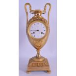 A STYLISH EARLY 19TH CENTURY FRENCH EMPIRE TWIN HANDLED MANTEL CLOCK overlaid with vines, the