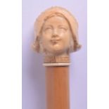 A LATE 19TH CENTURY EUROPEAN CARVED IVORY HANDLED WALKING CANE in the form of a Dutch girl. 83 cm