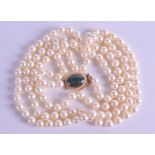 A 14CT GOLD MOUNTED AKOYA CULTURED PEARL 6.5MM NECKLACE with nephrite jade clasp. 92 cm long.