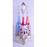 A LATE 19TH CENTURY SILVER PLATED TRIPLE DECANTER STAND containing three bohemian decanters,
