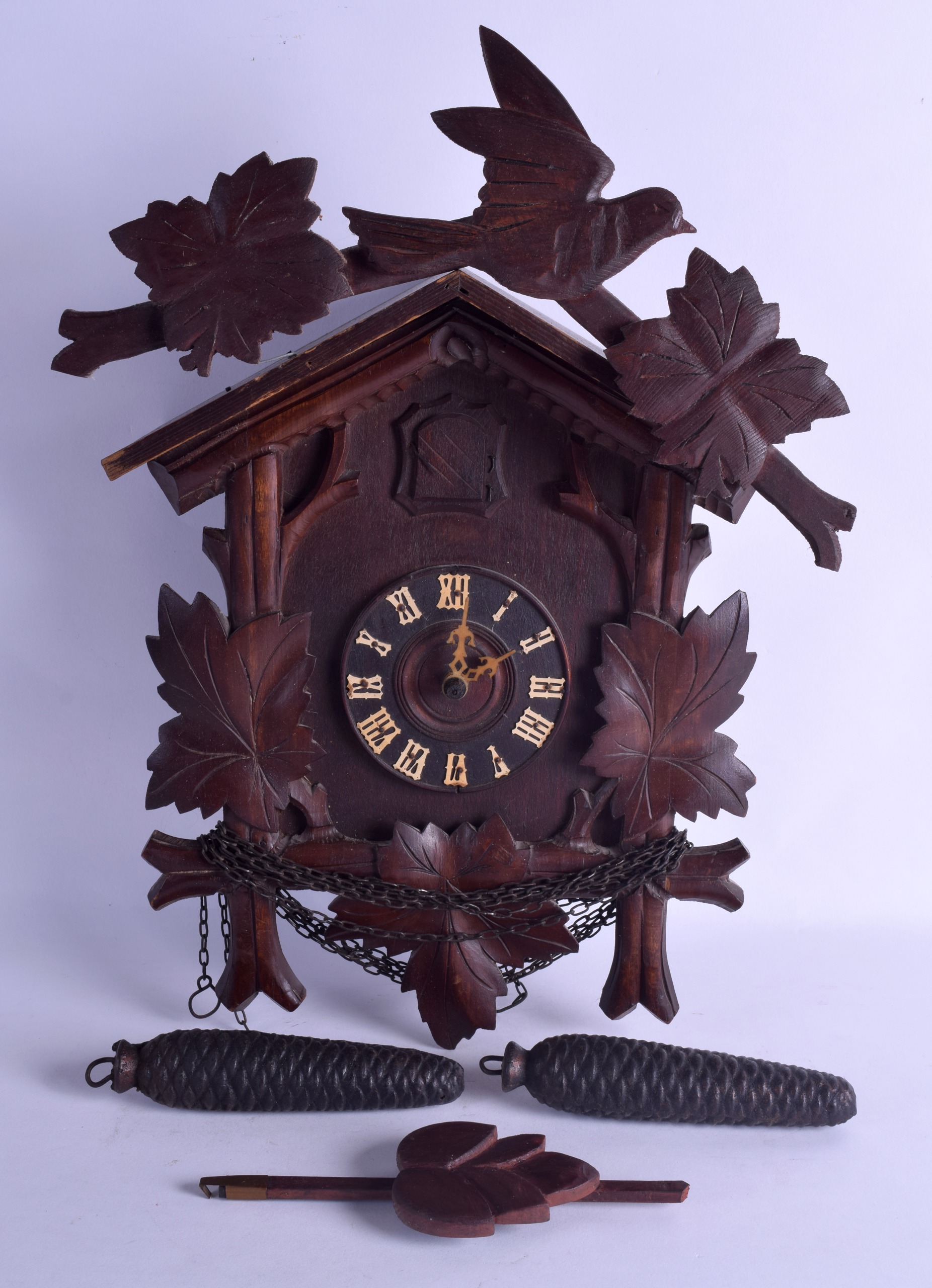 AN EARLY 20TH CENTURY BAVARIAN BLACK FOREST CUCKOO CLOCK of naturalistic form. 30 cm x 36 cm.