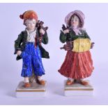 A PAIR OF LATE 19TH CENTURY GERMAN PORCELAIN FIGURES modelled as a boy and girl carrying logs. 15 cm