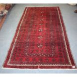 A BALUCH RED GROUND RUG, decorated with motifs. 225 cm x 119 cm.