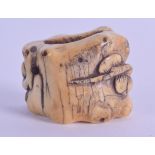 AN 18TH CENTURY JAPANESE EDO PERIOD CARVED IVORY SCROLL WEIGHT of naturalistic form. 3 cm x 3 cm.