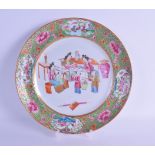 A MID 19TH CENTURY CHINESE CANTON FAMILLE ROSE PORCELAIN PLATE painted with figures seated beside