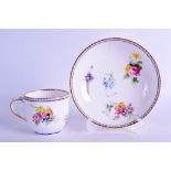 Sevres coffee cup and saucer painted with floral bouquets under a dentil gilt and blue line border ,