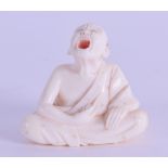 A LATE 19TH CENTURY JAPANESE MEIJI PERIOD CARVED IVORY NETSUKE modelled as a scowling male