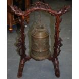 A GOOD CHINESE BRONZE HANGING BELL, in a carved hardwood frame of naturalistic form. 68 cm high.