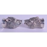 A PAIR OF STERLING SILVER WILD BOAR HEAD CONDIMENTS.