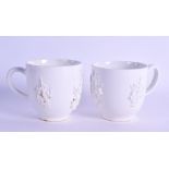 Bow coffee cup in white with applied prunus decoration and another similar.