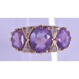 AN ANTIQUE 9CT GOLD AND TRIPLE AMETHYST RING. Size P/Q.