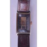 A 1930S GENTLEMANS YELLOW METAL AND STEEL WRISTWATCH with rectangular black and gilt dial. 2 cm x