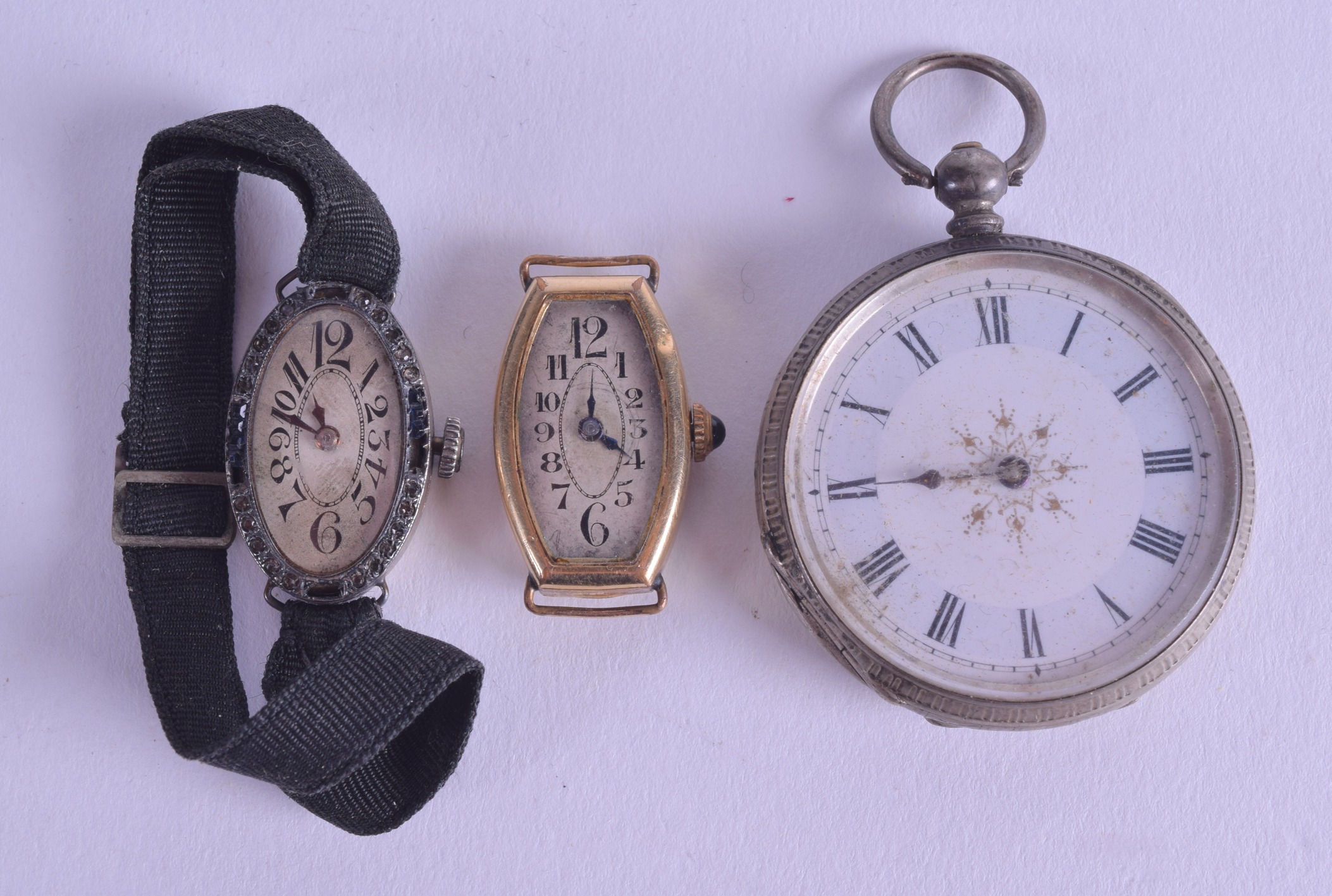 AN ANTIQUE SILVER POCKET WATCH together with two other 1930s watch movements & dials. (3)