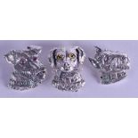 THREE NOVELTY SILVER DOG HEAD BROOCHES. (3)