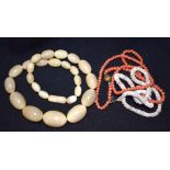 A COW HORN NECKLACE, together with coral and shell. (3)