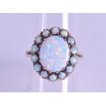 A 9CT GOLD AND OPAL CLUSTER RING. Size O.