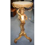 A GOOD 19TH CENTURY CARVED GILTWOOD MERMAN TORCHERE, finely carved on three curved legs. 89 cm