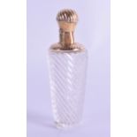 A 19TH CENTURY FRENCH GOLD TOPPED SPIRALLY MOULDED SCENT BOTTLE with similar spirally formed gold