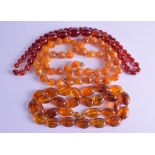 A GROUP OF THREE AMBER TYPE NECKLACES. 82 cm, 64 cm & 82 cm long. (3)