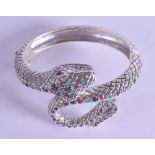 A SILVER EMERALD RUBY AND SAPPHIRE SNAKE BANGLE.