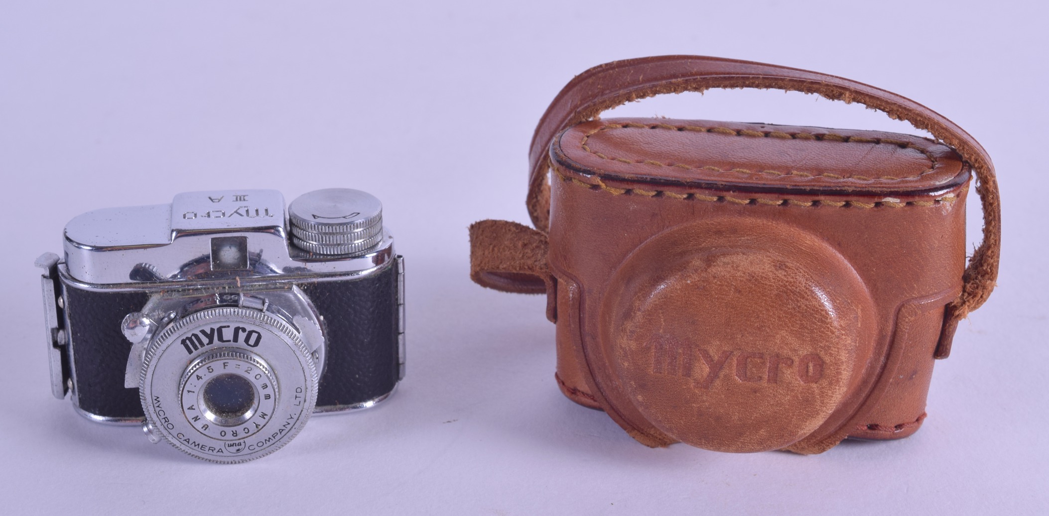 A RARE MYCRO SPY CAMERA within original leather case. 5.25 cm wide.