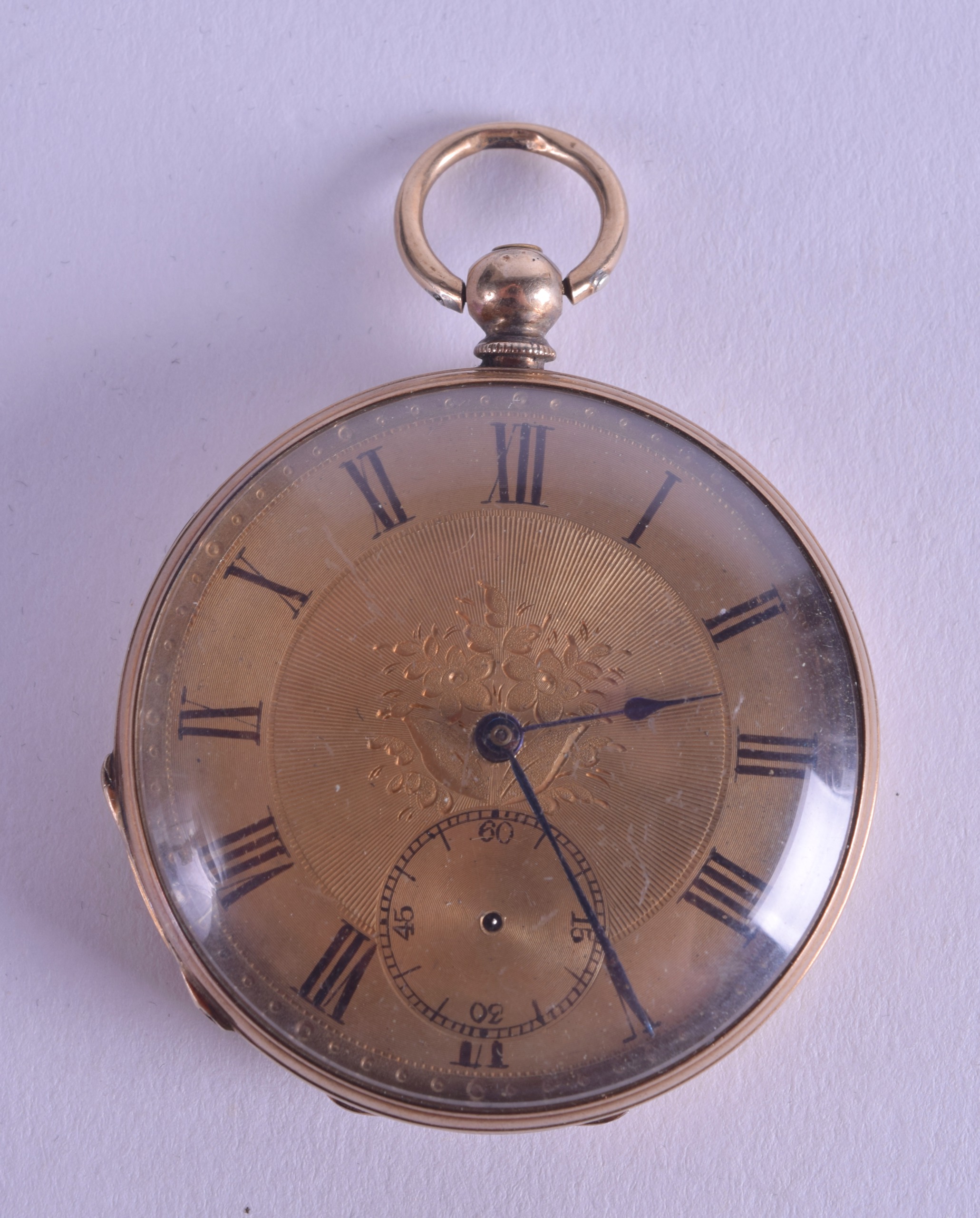 AN ANTIQUE YELLOW METAL POCKET WATCH with gilt dial and black numerals. 4.5 cm diameter.