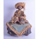 A RARE LATE VICTORIAN AUTOMATON MUSICAL FIGURE OF A TURKISH BOY modelled seated holding a wand,