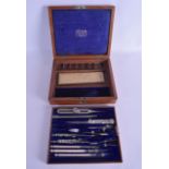 AN ANTIQUE CASED SCIENTIFIC INSTRUMENT SET with carved ivory handles, retailed by J & W E Archbutt