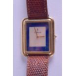 A STYLISH 18CT GOLD AND LAPIS LAZULI CORUM WRISTWATCH with square dial and gem set winder. 2.5 cm