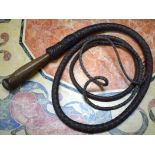 AN EARLY 20TH CENTURY LEATHER WHIP, with wooden handle.