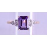 A 9CT EMERALD CUT DIAMOND AND AMETHYST RING. Size N.